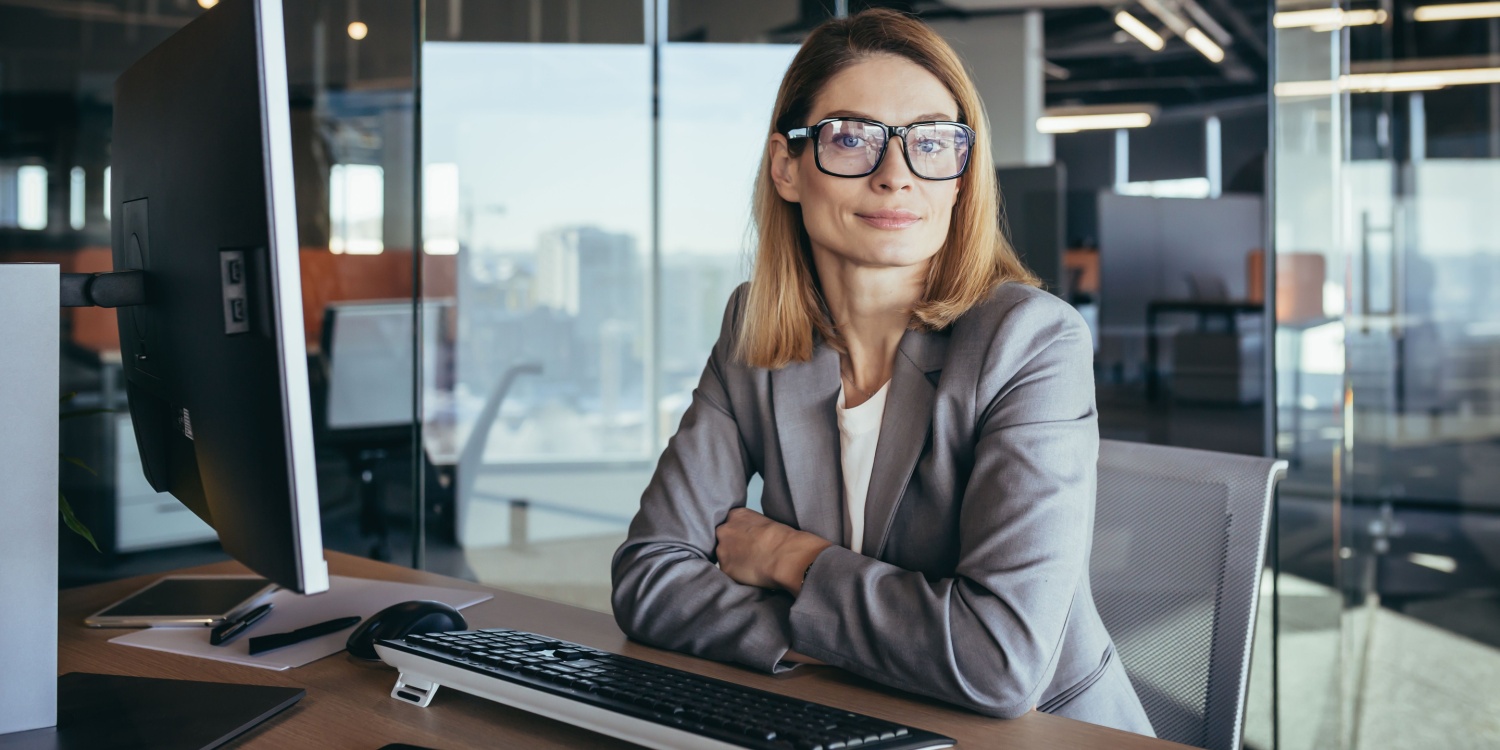 Portrait of a confident and successful female business owner sitting at a desk in a modern office.